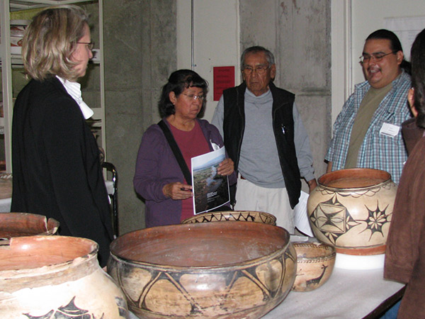 Conservators, Larry Humetewa and Landis Smith, consult with potter Martha Arquero of Cochiti Pueblo on pottery technology and conservation treatment options.