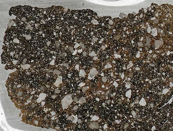 Example of petrographic slide showing tiny rocks included in clay.